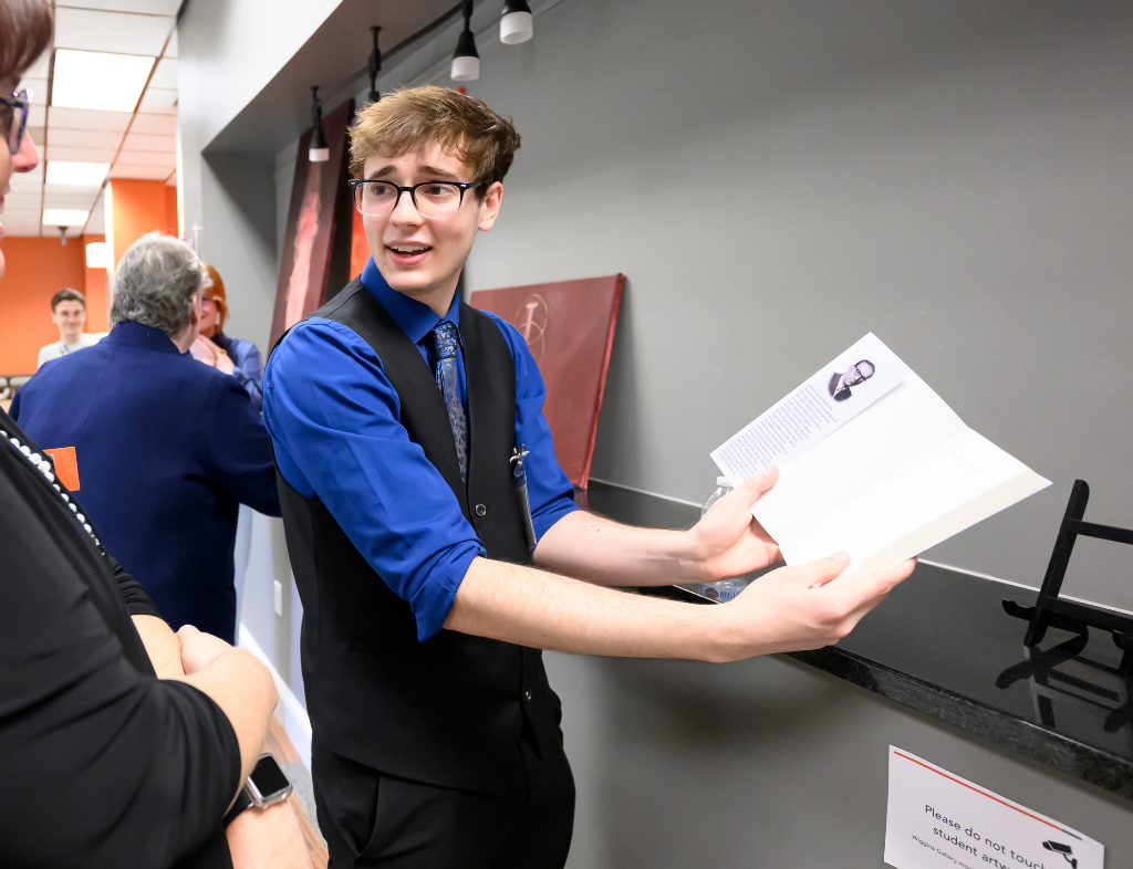 Artist Joshua Sledge showcases Merit winning design to Symposium spectator. Photo curtesy of Bennet Scarborough Photography